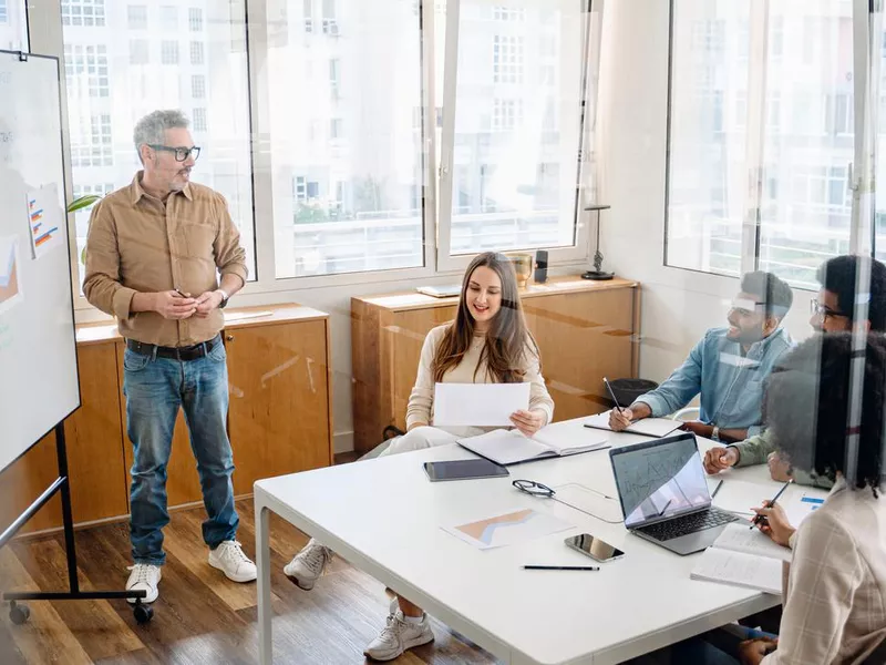 Colleagues engage in a lively exchange of ideas in an office